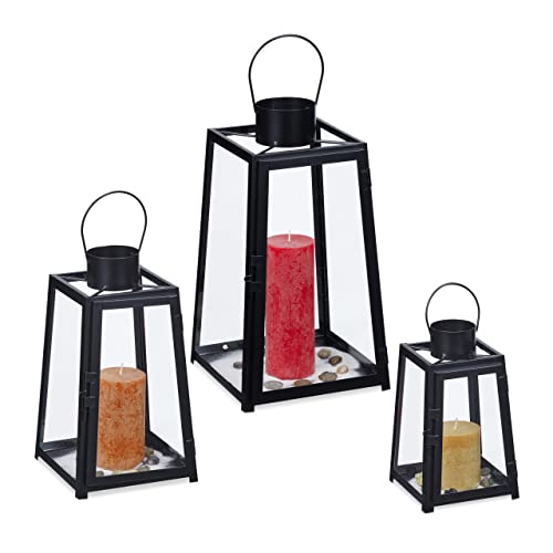 Set of three decorative lanterns in varying sizes made of black metal and glass, designed for use indoors and outdoors, featuring a retro style suitable for holding candles.