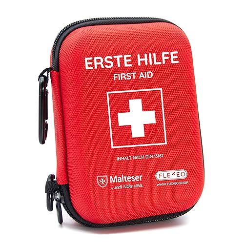 A comprehensive first aid kit designed for outdoor activities travel motorcycle use and sports featuring items that meet DIN 13167 standards