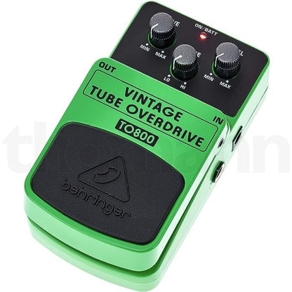 Vintage Tube Overdrive pedal by Behringer in lime green, featuring dedicated Drive, Tone, and Level controls, dimensions of 6.45"L x 3.6"W x 2.5"H, and a weight of 0.9 pounds; includes status LED for effect on/off and battery check with analog signal format powered by a single 9V battery.