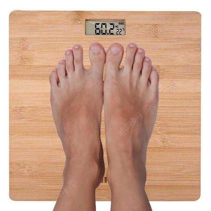 Brown wooden bamboo digital personal scale with an LCD display, designed for precision weighing up to 180 kilograms, featuring a portable and lightweight design that allows for easy storage under furniture.